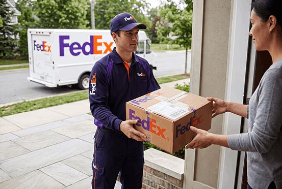 FedEx courier delivering a package of custom flight tags to a customer